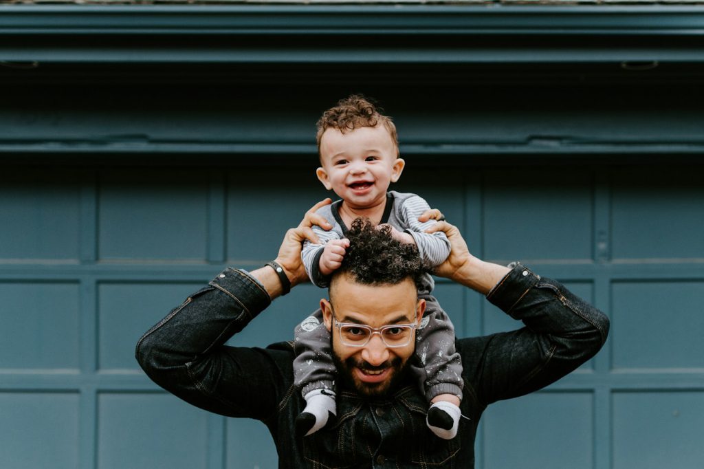 A father carrying his child on his shoulders